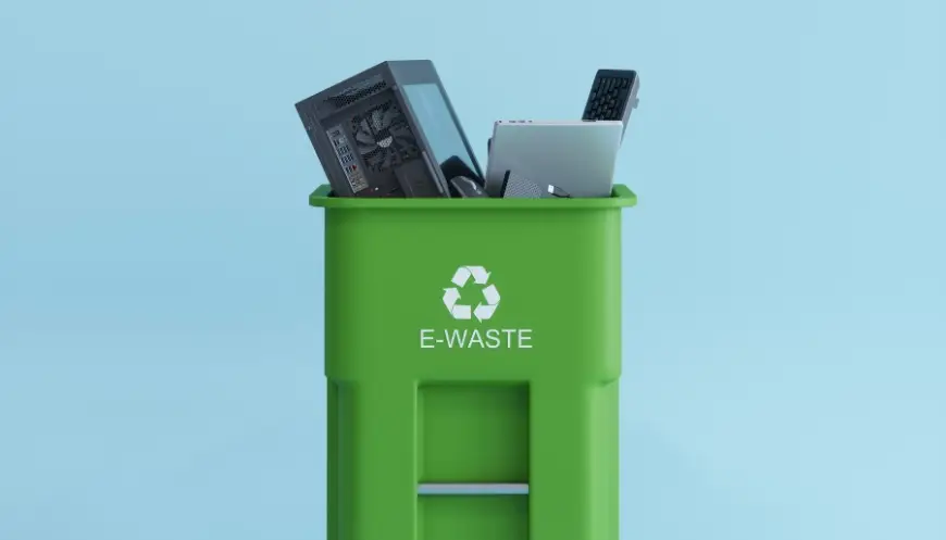 Green e-waste recycling bin filled with old electronics.